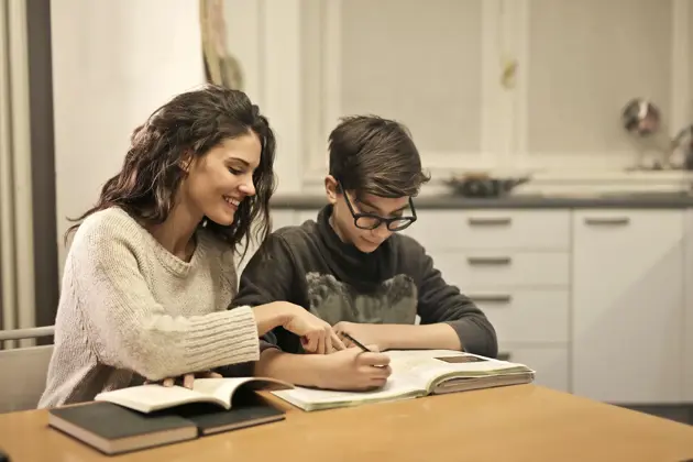 Elder Sister And Brother Studying At Home